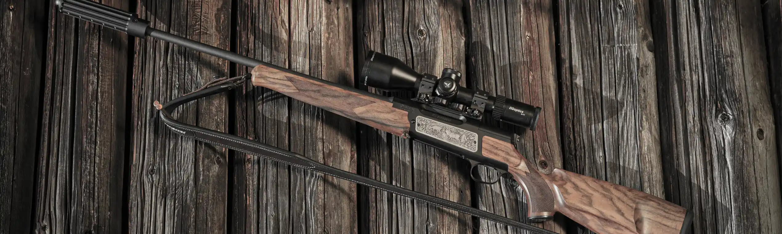 DDoptics hunting riflescope mounted on a hunting rifle against rustic wood