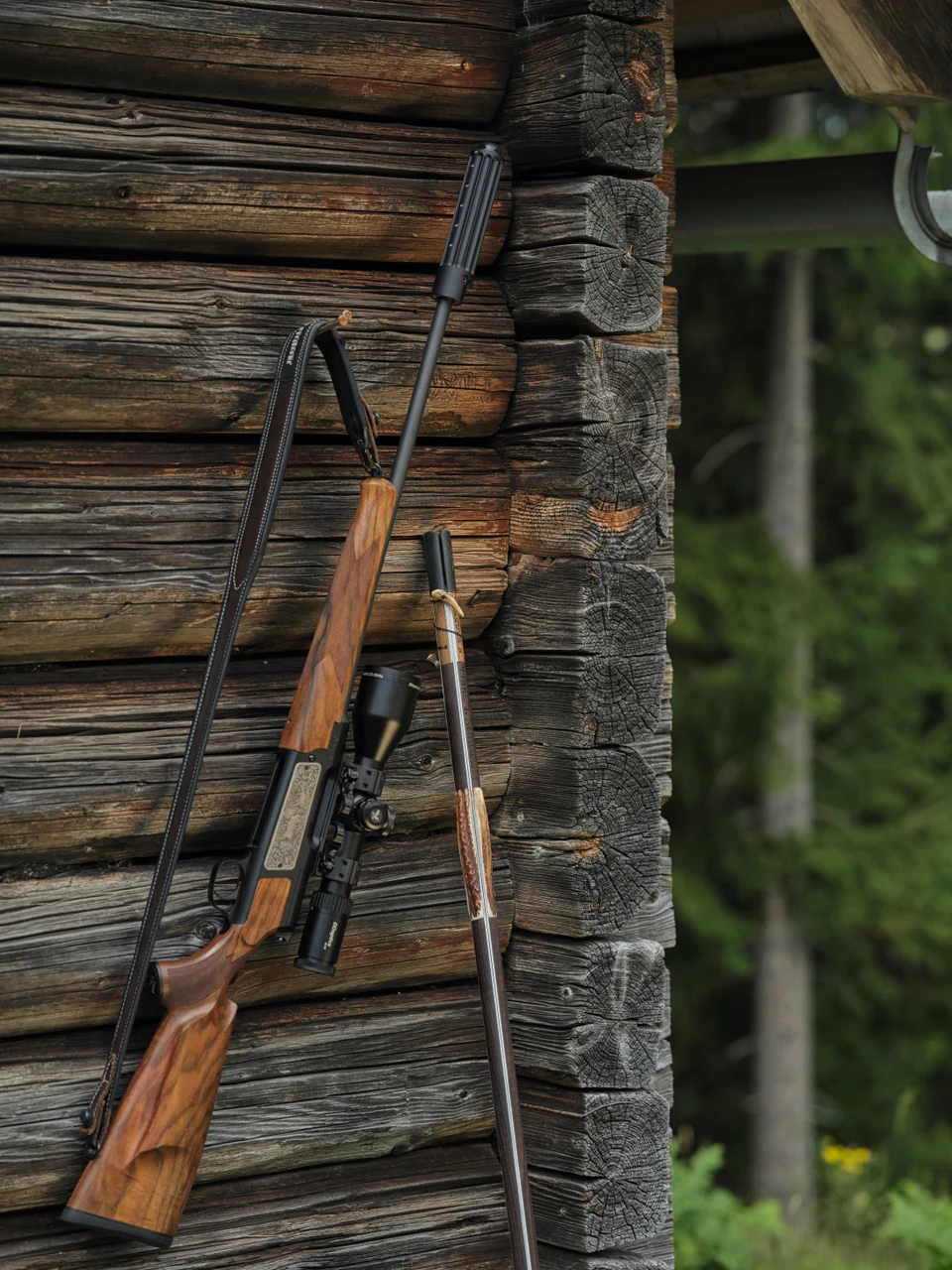 NFX 2.5–20×56 beside a wooden cabin